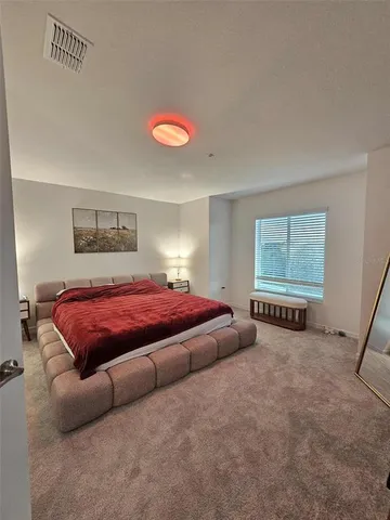 a bedroom with a bed and a couch