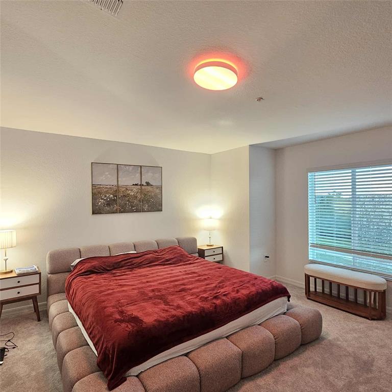 17470 Opal Sand Drive, Unit 201 Venice, FL 34293 - Photo 24 of 49 a bedroom with a bed and a couch