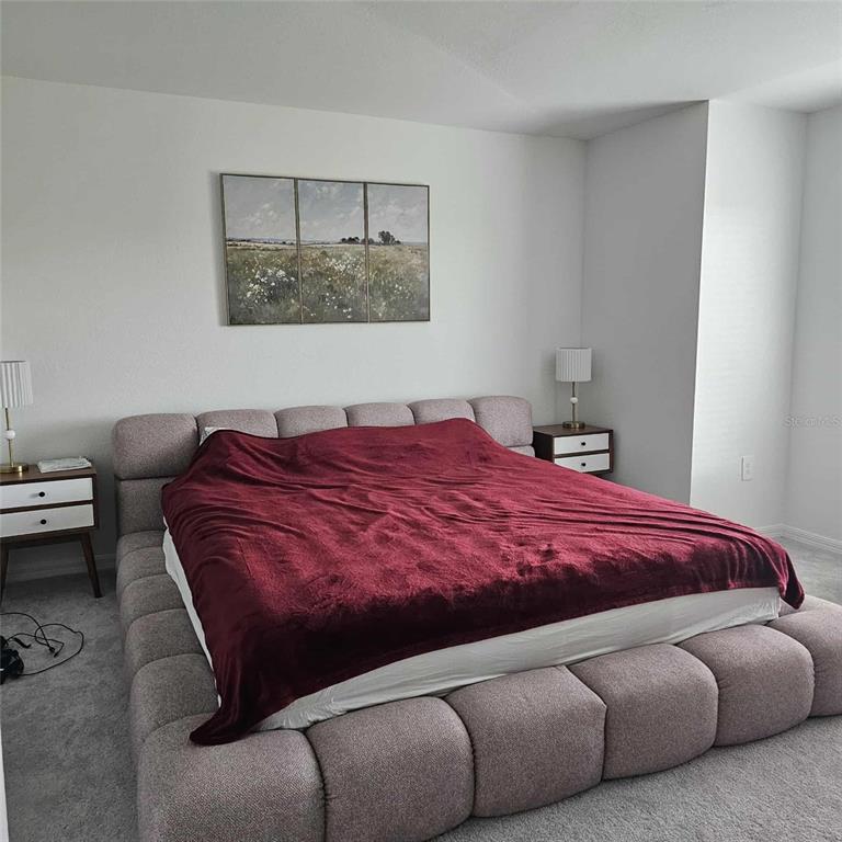 17470 Opal Sand Drive, Unit 201 Venice, FL 34293 - Photo 26 of 49 a bedroom with a bed and window