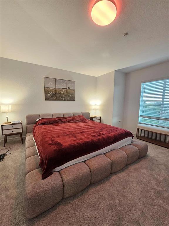 17470 Opal Sand Drive, Unit 201 Venice, FL 34293 - Photo 27 of 49 a spacious bedroom with a bed and window