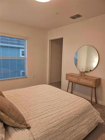 a bedroom with a bed and a night stand