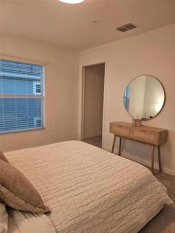 a bedroom with a bed and a night stand