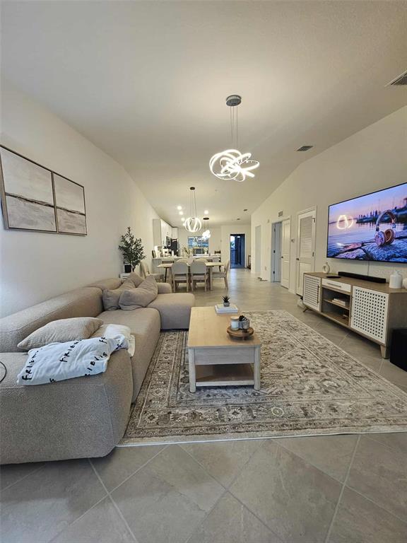 17470 Opal Sand Drive, Unit 201 Venice, FL 34293 - Photo 3 of 49 a living room with furniture and a flat screen tv
