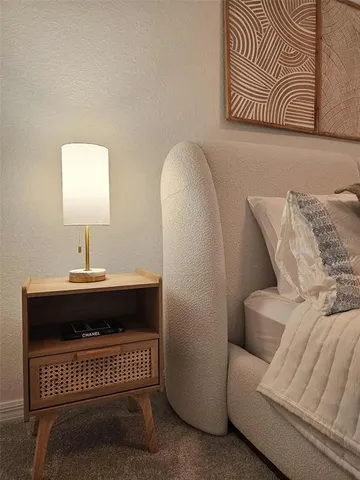 a bedroom with a bed and a night stand