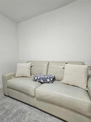 a room with a table chairs and wooden floor