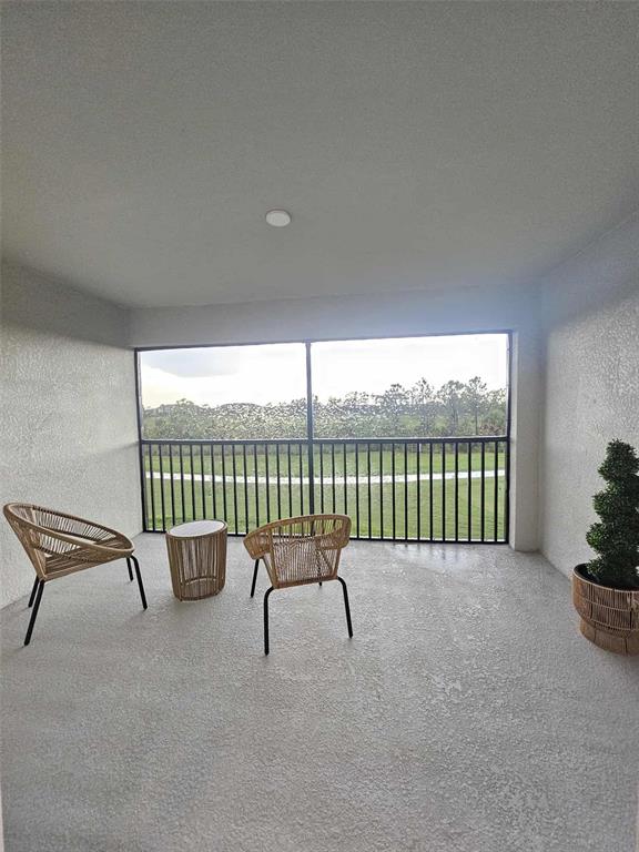 17470 Opal Sand Drive, Unit 201 Venice, FL 34293 - Photo 40 of 49 a view of a chair and table