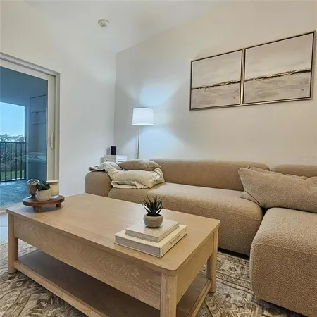 a living room with furniture and a table