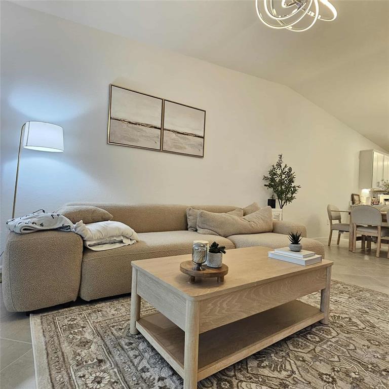 17470 Opal Sand Drive, Unit 201 Venice, FL 34293 - Photo 44 of 49 a living room with furniture and a table