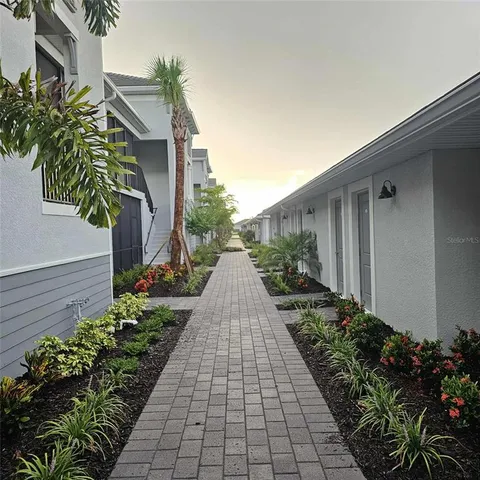 a view of a pathway that has potted plants