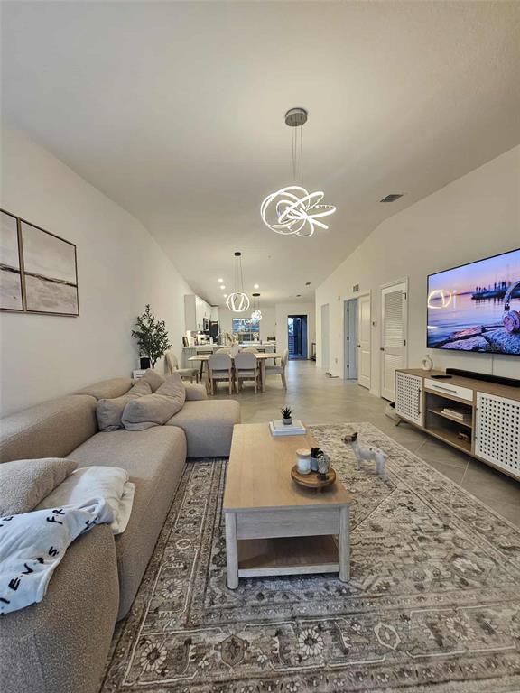 17470 Opal Sand Drive, Unit 201 Venice, FL 34293 - Photo 5 of 49 a living room with furniture and a flat screen tv
