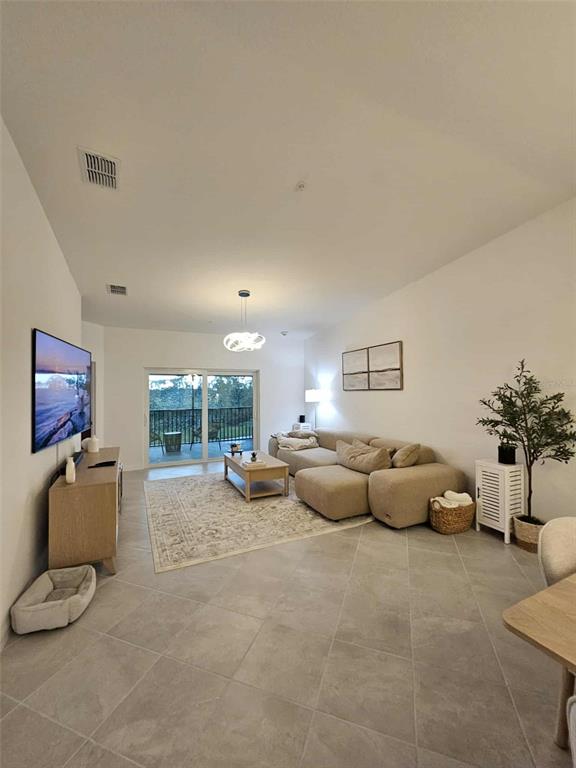 17470 Opal Sand Drive, Unit 201 Venice, FL 34293 - Photo 6 of 49 a living room with furniture and a couch