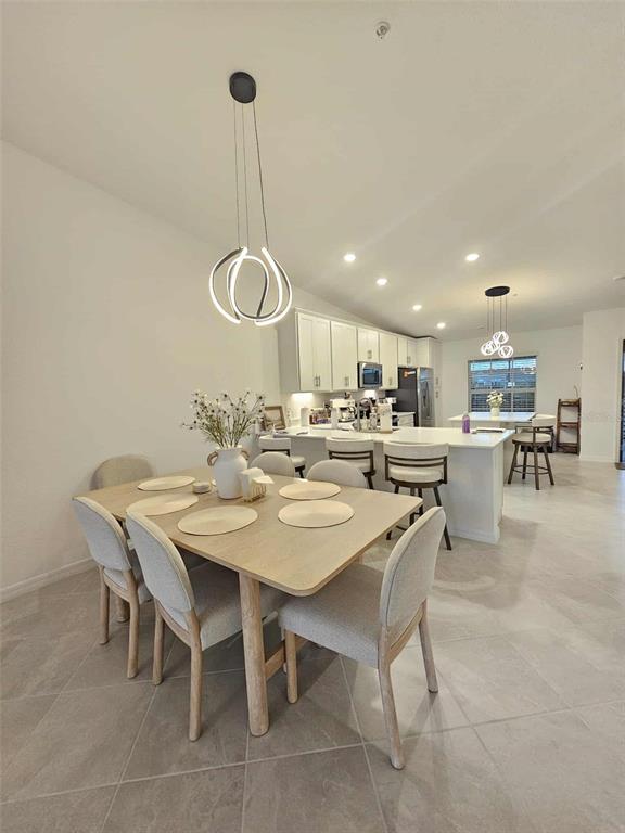 17470 Opal Sand Drive, Unit 201 Venice, FL 34293 - Photo 10 of 49 a dining room with a table a chairs and a table