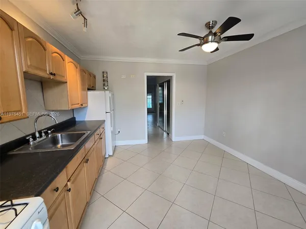 a kitchen with a sink cabinets and appliances