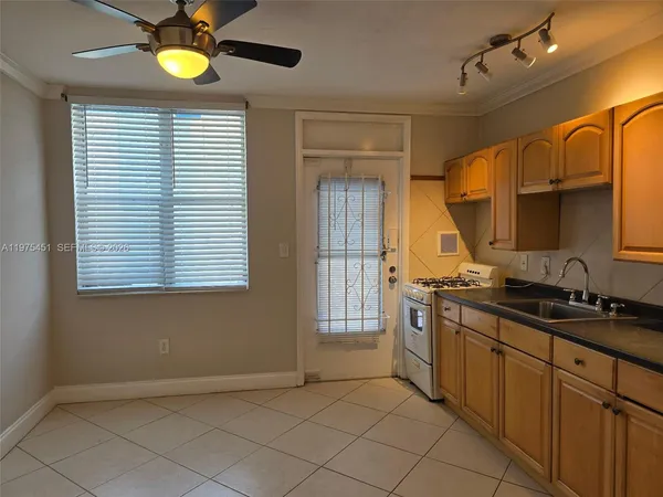 a kitchen with stainless steel appliances granite countertop a sink and a stove