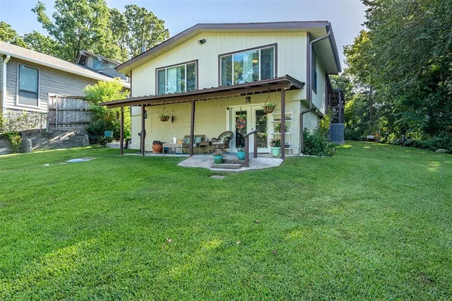 a view of a house with a yard and sitting area