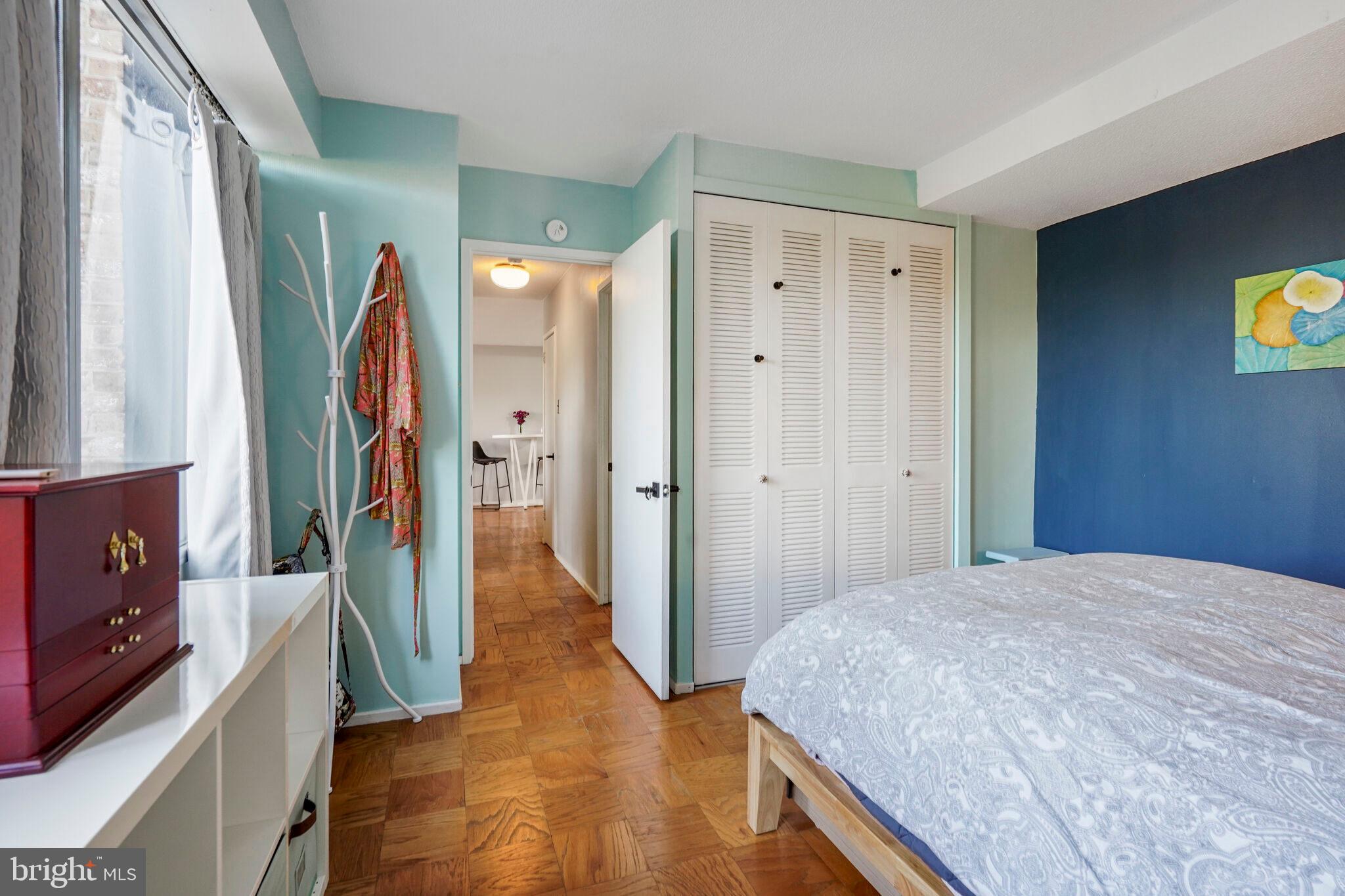 1301 Delaware Avenue Southwest, Unit N514 Washington, DC 20024 - Photo 11 of 44 a bedroom with a bed and a flat tv screen on dresser