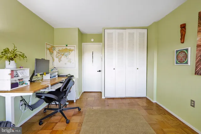 a bedroom with a bed and a flat tv screen in it