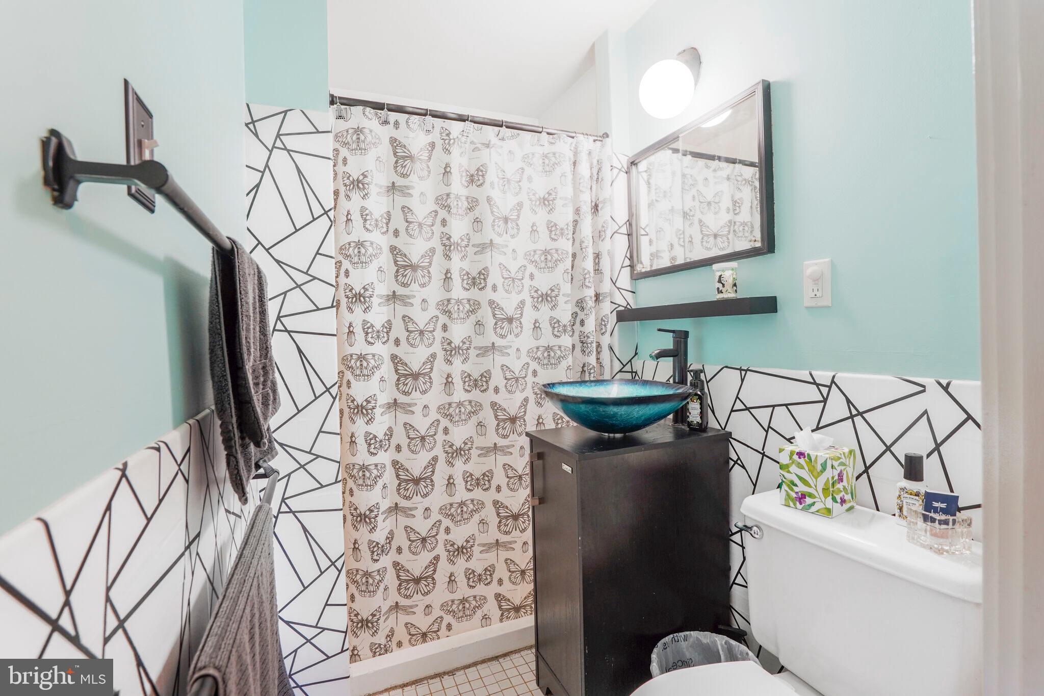 1301 Delaware Avenue Southwest, Unit N514 Washington, DC 20024 - Photo 16 of 44 a bathroom with a sink toilet and mirror