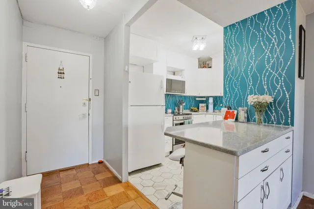 a kitchen with a stove a sink and a refrigerator