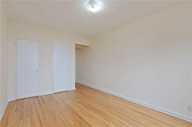 a view of a room with wooden floor