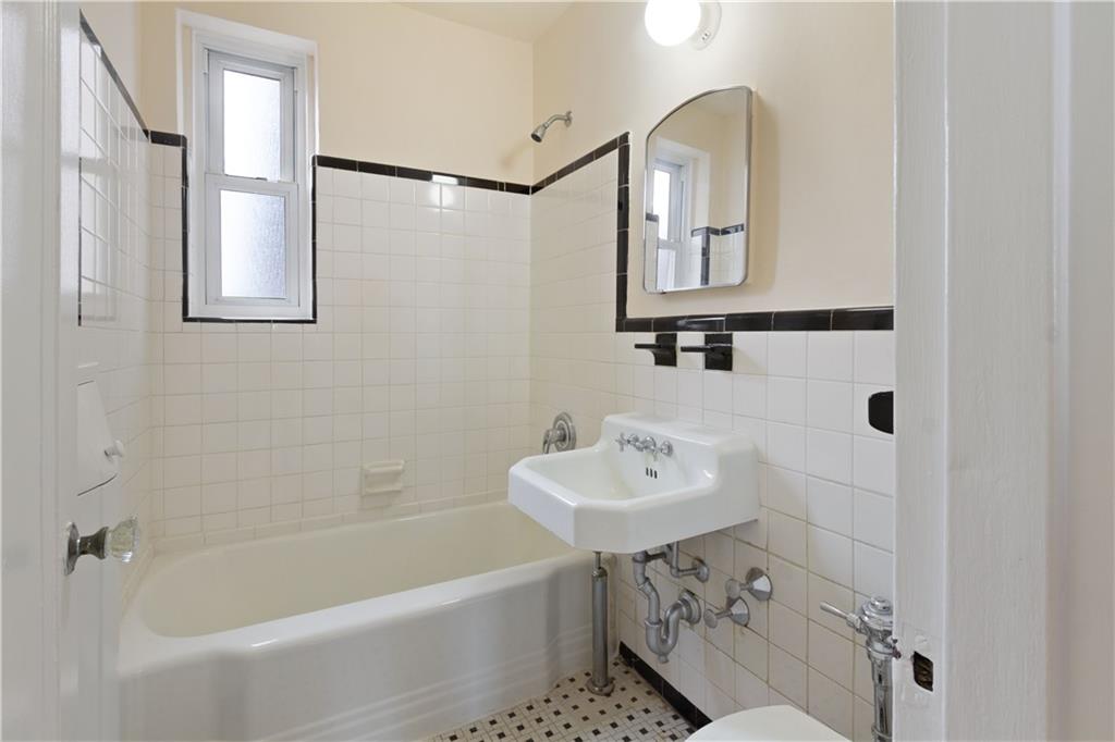 6801 Shore Road, Unit 5U Brooklyn, NY 11220 - Photo 15 of 21 a bathroom with a sink a toilet and bathtub