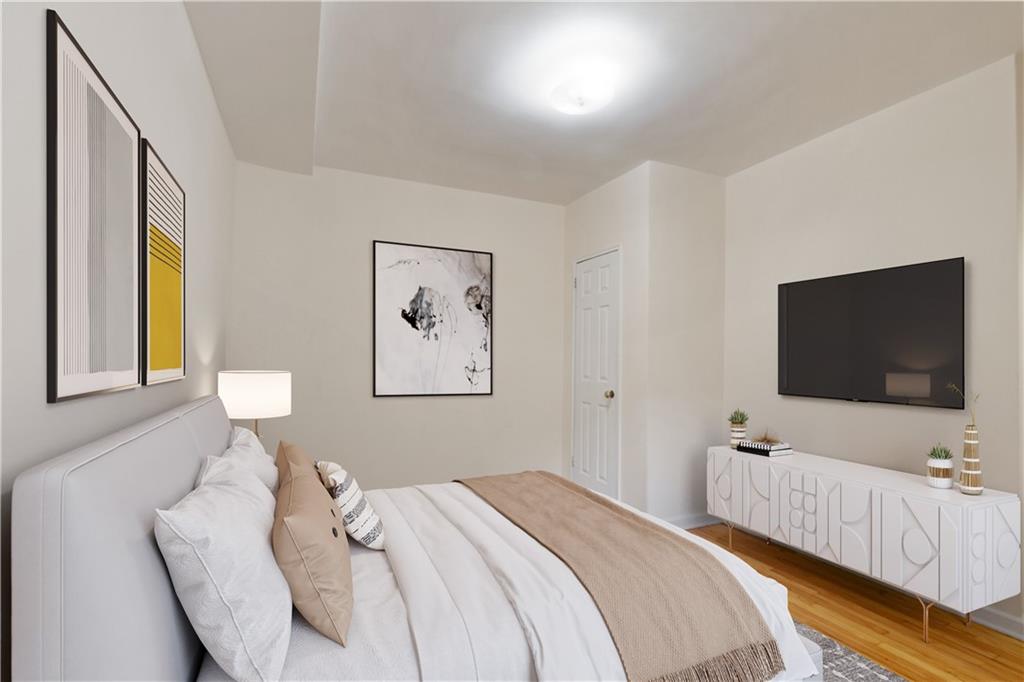6801 Shore Road, Unit 5U Brooklyn, NY 11220 - Photo 16 of 21 a bedroom with bed and a flat screen tv