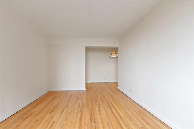 a view of a room with wooden floor