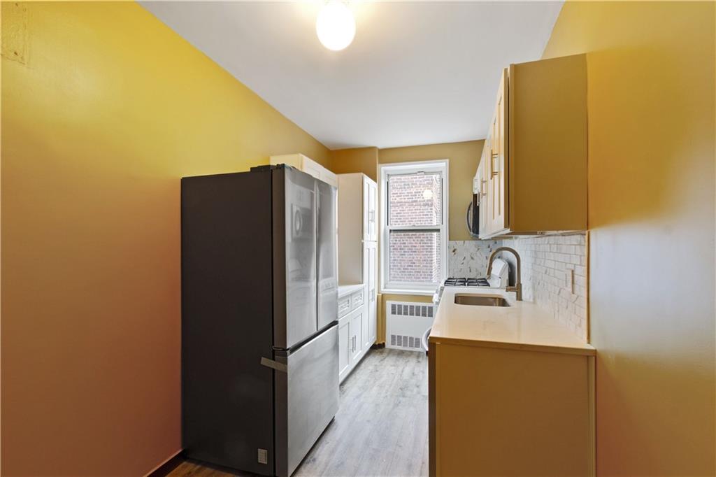6801 Shore Road, Unit 5U Brooklyn, NY 11220 - Photo 7 of 21 a kitchen with a refrigerator and a sink