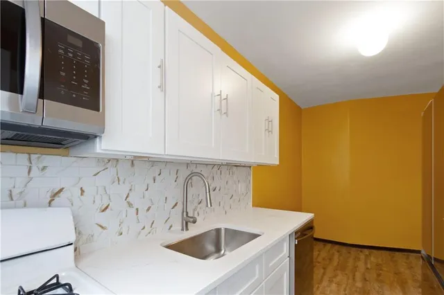 a bathroom with a sink a mirror and a shower