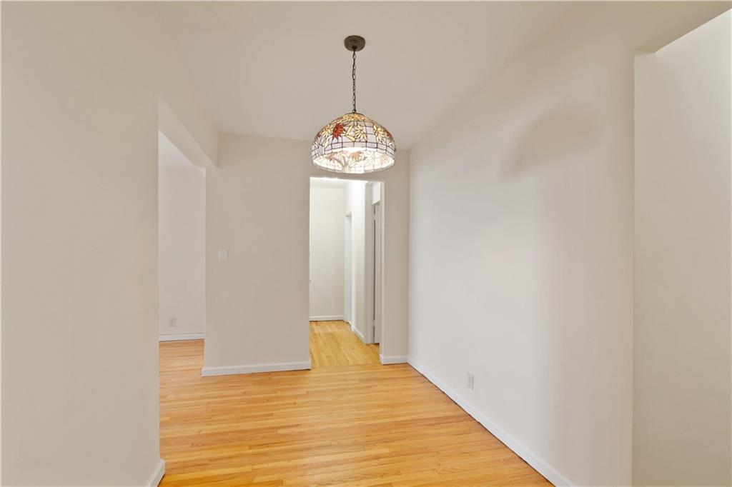 6801 Shore Road, Unit 5U Brooklyn, NY 11220 - Photo 10 of 21 a view of a hallway with wooden floor and a window