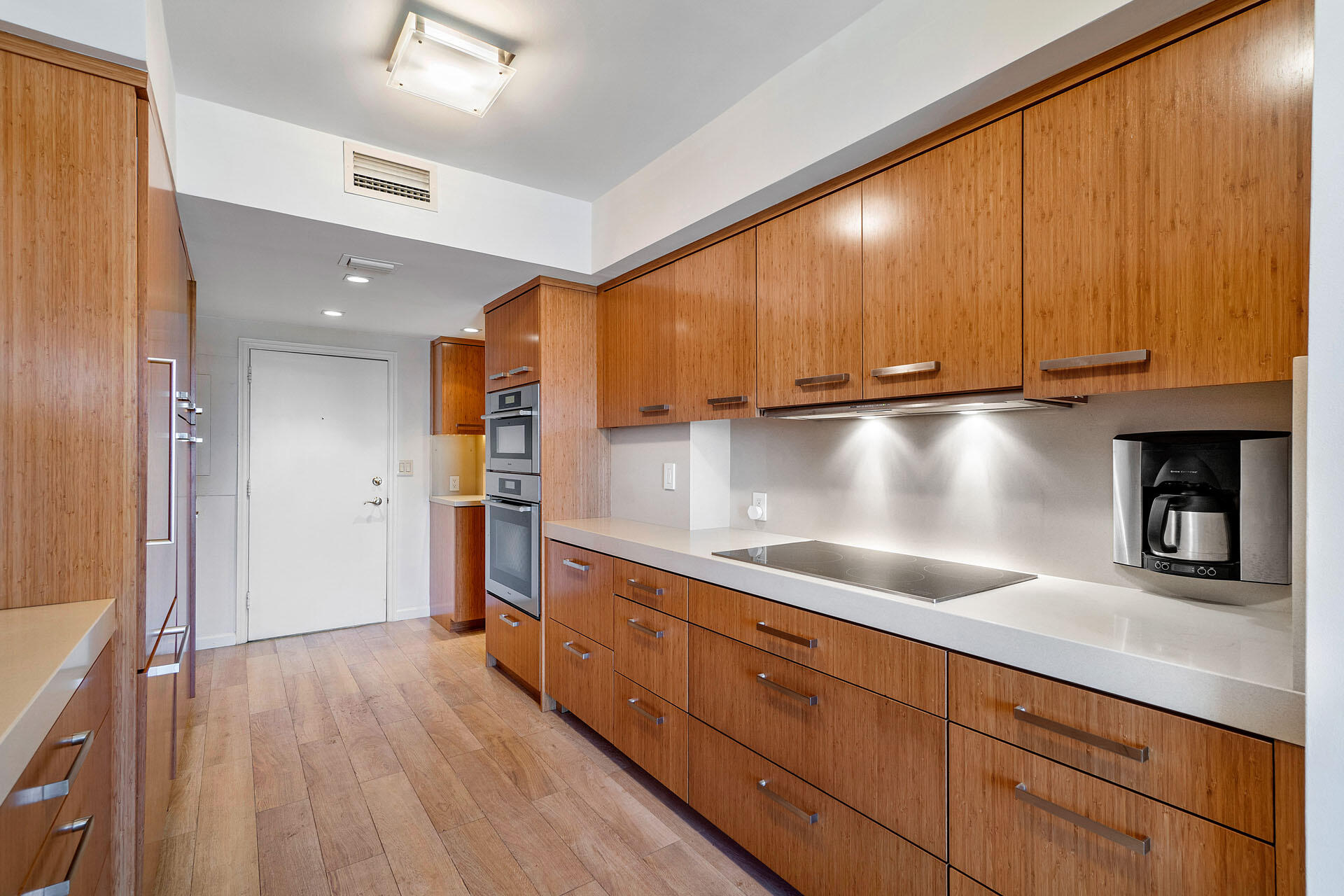 750 South Ocean Boulevard, Unit 5N Boca Raton, FL 33432 - Photo 12 of 30 a kitchen with granite countertop wooden cabinets a sink and stainless steel appliances