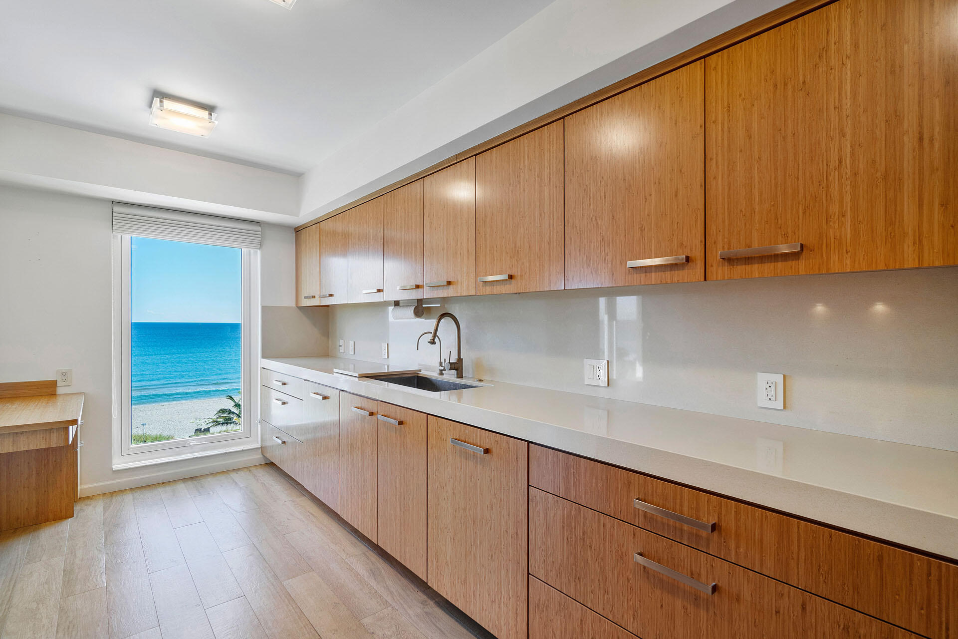 750 South Ocean Boulevard, Unit 5N Boca Raton, FL 33432 - Photo 13 of 30 a kitchen with sink cabinets and a window