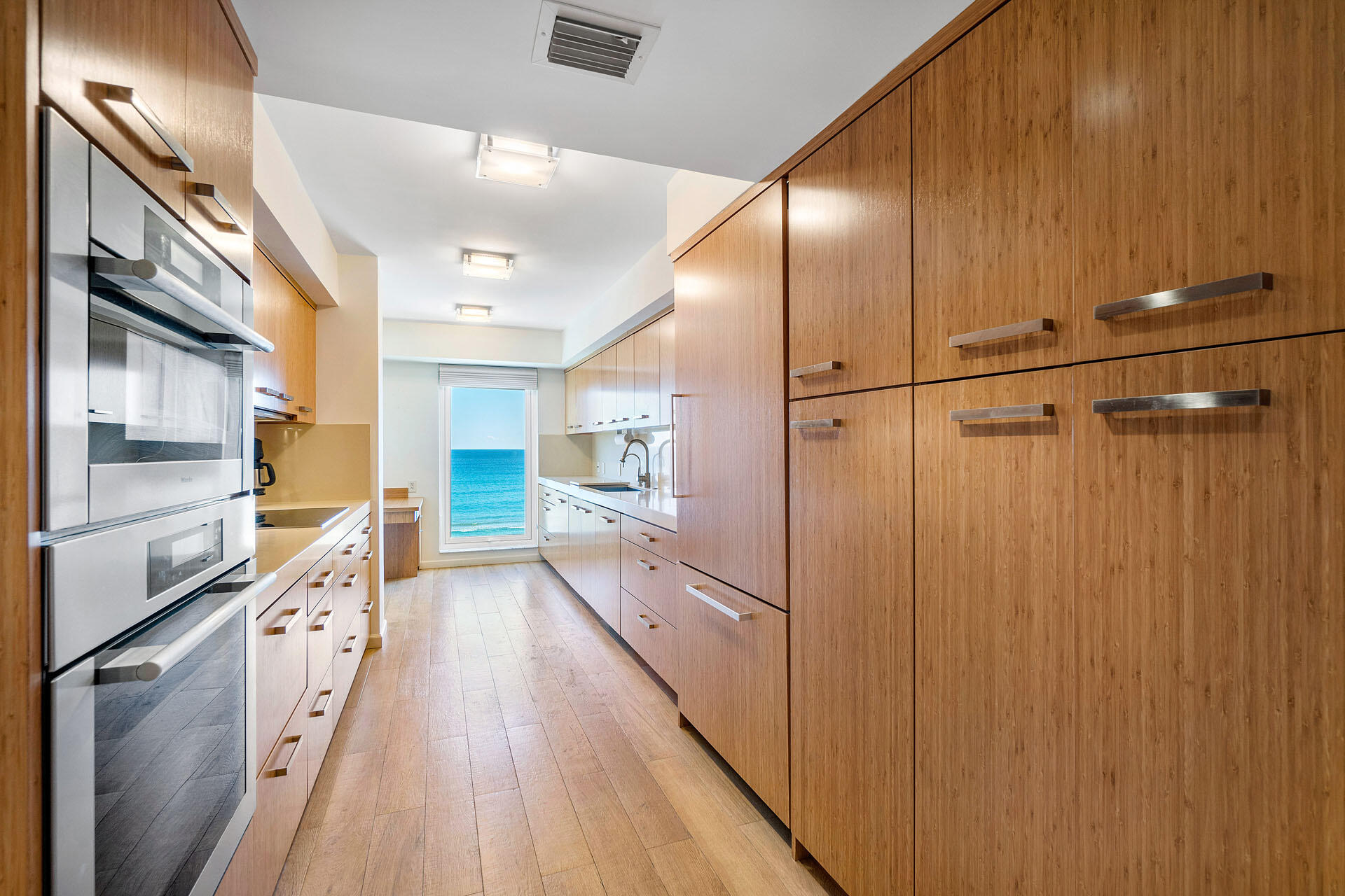 750 South Ocean Boulevard, Unit 5N Boca Raton, FL 33432 - Photo 14 of 30 a kitchen with granite countertop stainless steel appliances a counter top space and cabinets