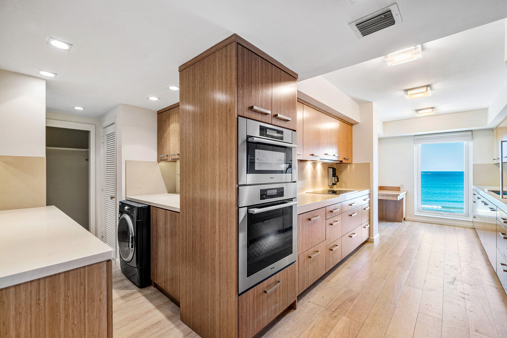 750 South Ocean Boulevard, Unit 5N Boca Raton, FL 33432 - Photo 15 of 30 a kitchen with stainless steel appliances kitchen island granite countertop a stove refrigerator and cabinets