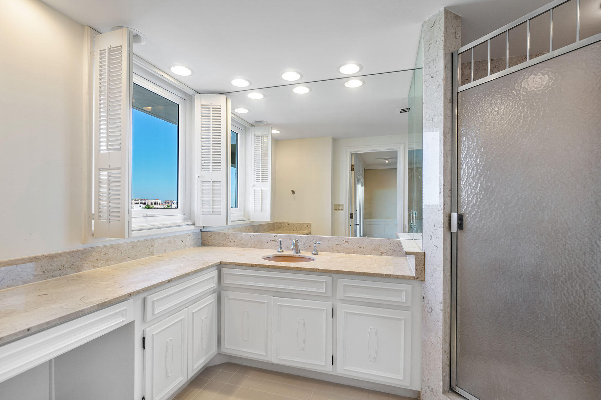 750 South Ocean Boulevard, Unit 5N Boca Raton, FL 33432 - Photo 19 of 30 a bathroom with a sink and a mirror