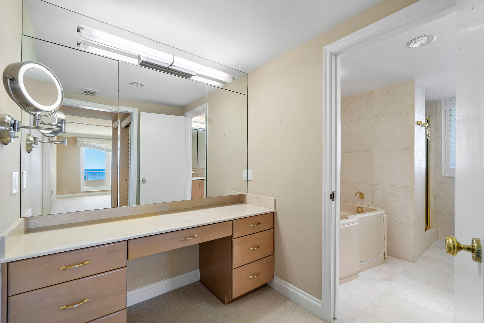 750 South Ocean Boulevard, Unit 5N Boca Raton, FL 33432 - Photo 20 of 30 a spacious bathroom with a double vanity sink a mirror and a bathtub