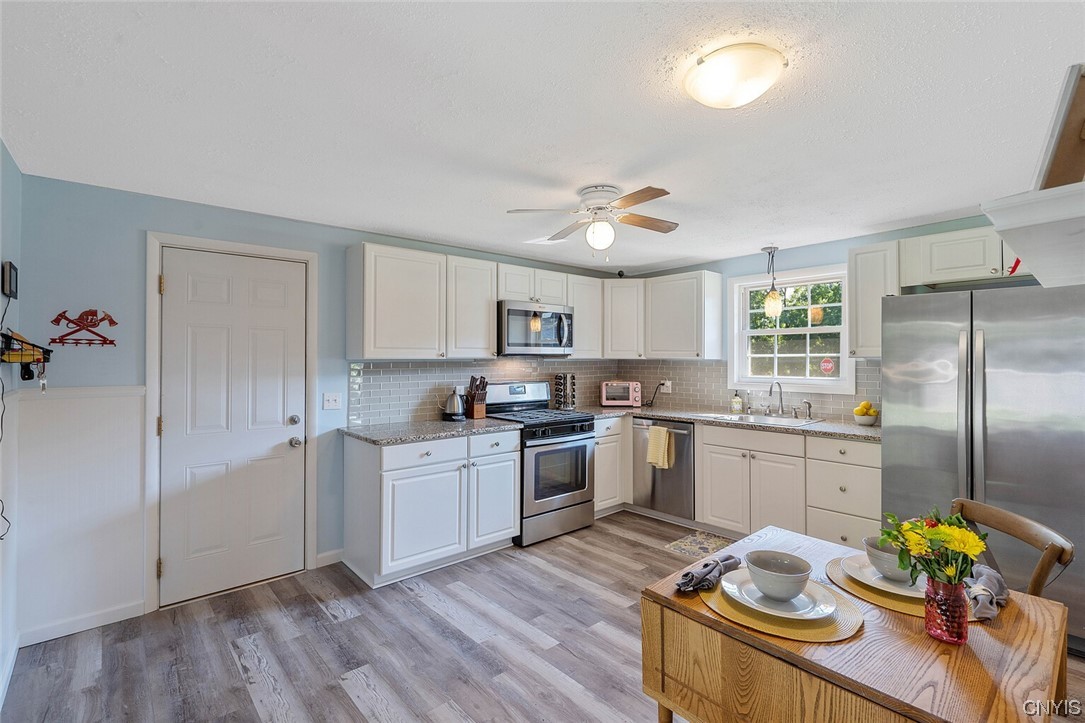 47 Macarthur Road Lysander, NY 13027 - Photo 13 of 34 Eat in kitchen with new luxury vinyl tile floors