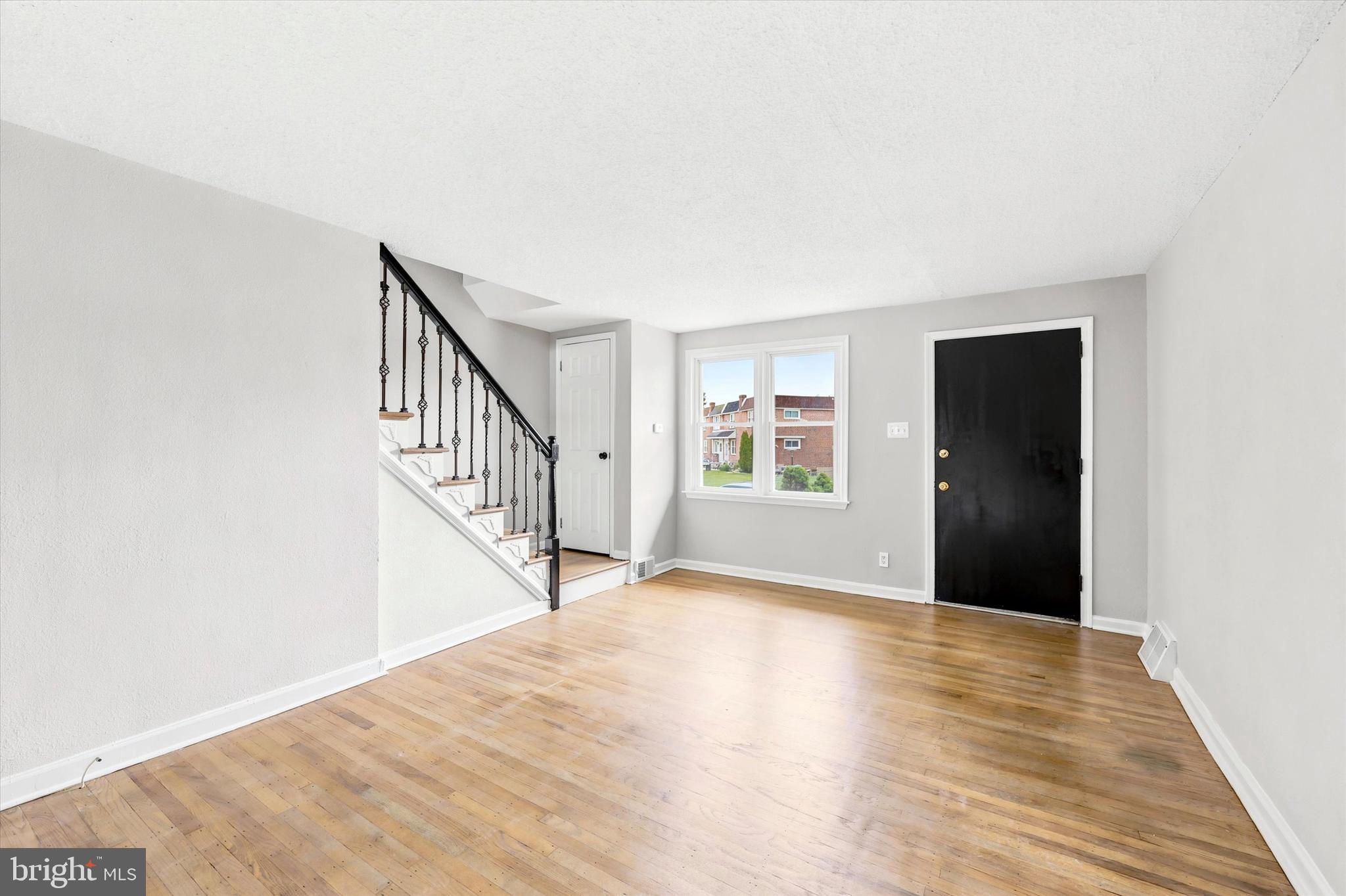 2052 Heather Road Folcroft, PA 19032 - Photo 3 of 17 a view of an empty room with wooden floor and a window