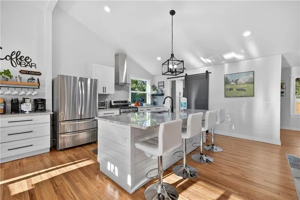 a kitchen with stainless steel appliances granite countertop a stove and a sink