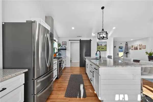 a kitchen with stainless steel appliances granite countertop a sink and a counter top space