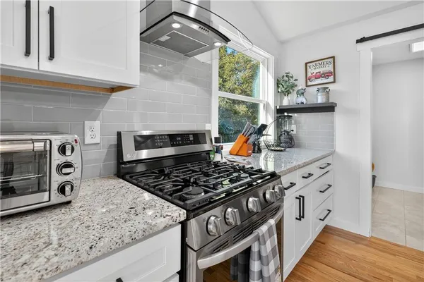 a large kitchen with stainless steel appliances kitchen island granite countertop a large island in the center