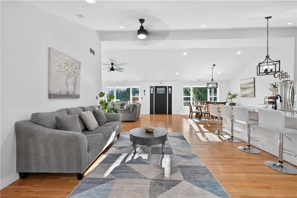 a living room with furniture and kitchen view