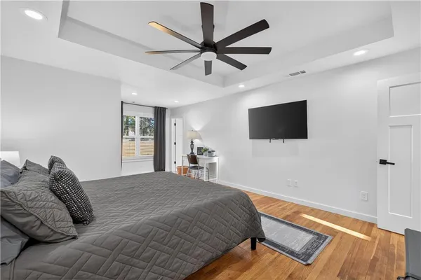 a bedroom with a large bed and a window
