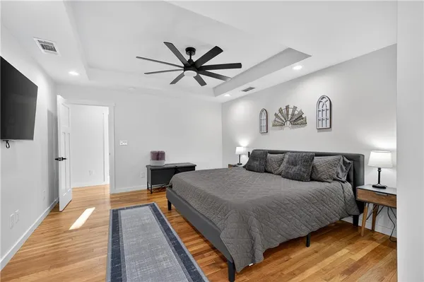 a bedroom with a bed and a chandelier