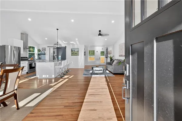 a living room with furniture a flat screen tv and a window