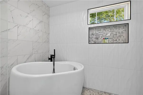 a view of a backyard with table and chairs and wooden fence