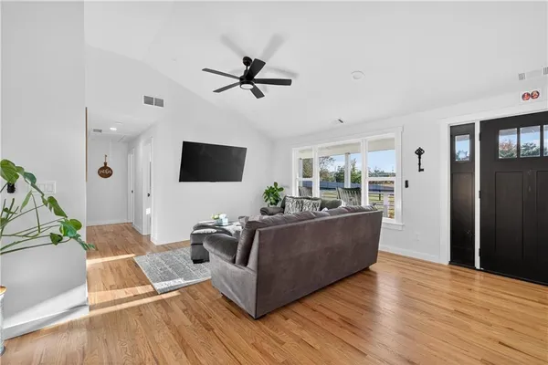 a living room with furniture and wooden floor