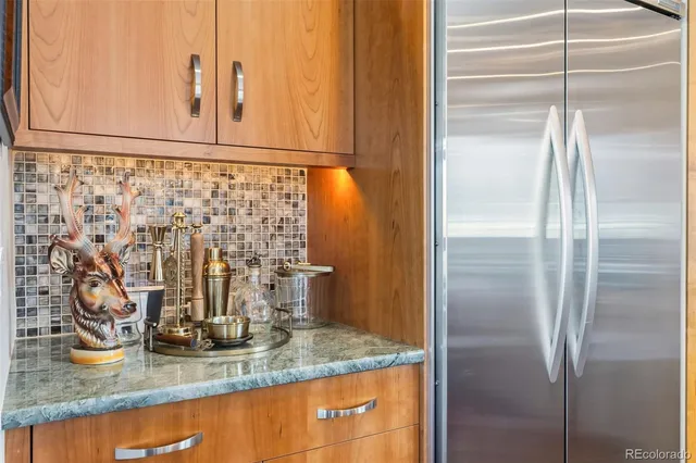 a kitchen with stainless steel appliances granite countertop a refrigerator and a sink