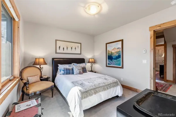 a bedroom with a bed and a couch