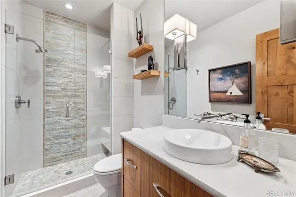 a bathroom with a sink toilet and shower